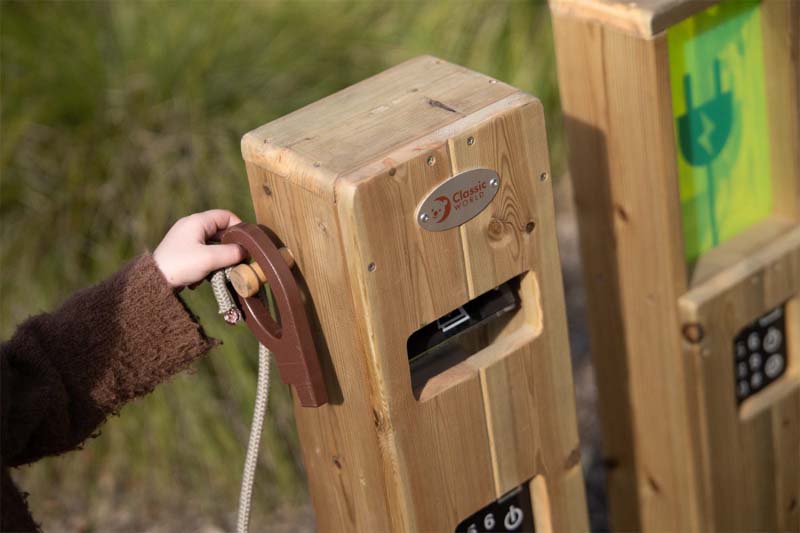A child operating the Classic Outdoor timber fuel and EV charging station