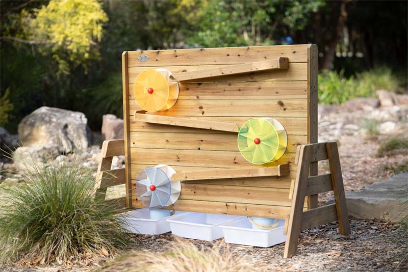 The Classic Outdoor timber water wall and trough in a garden
