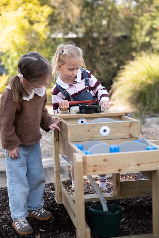 Two children playing at the Classic Outdoor timber water table in a garden
