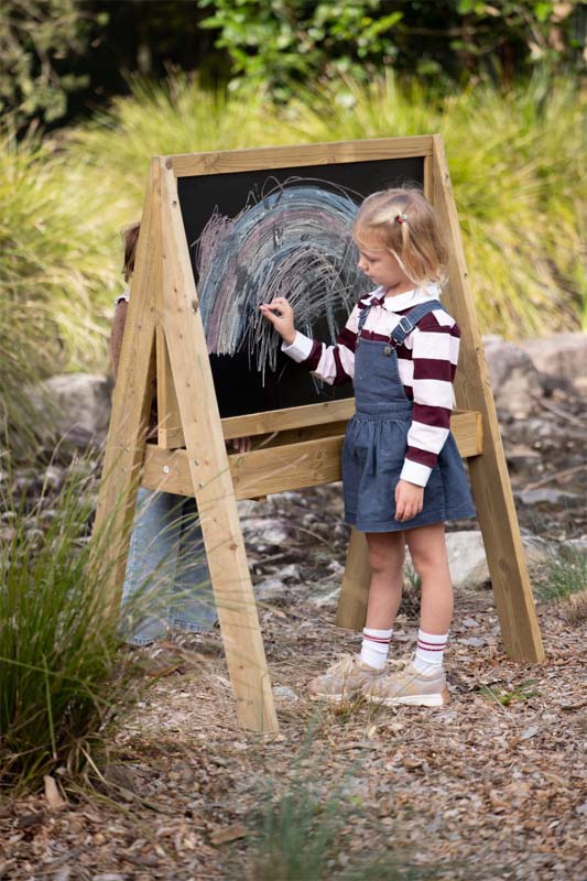A child setting the dials on the timber weather station