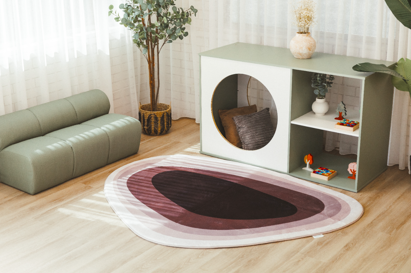 Sage modular lounge, cubby shelving unit and an organic-shaped rug